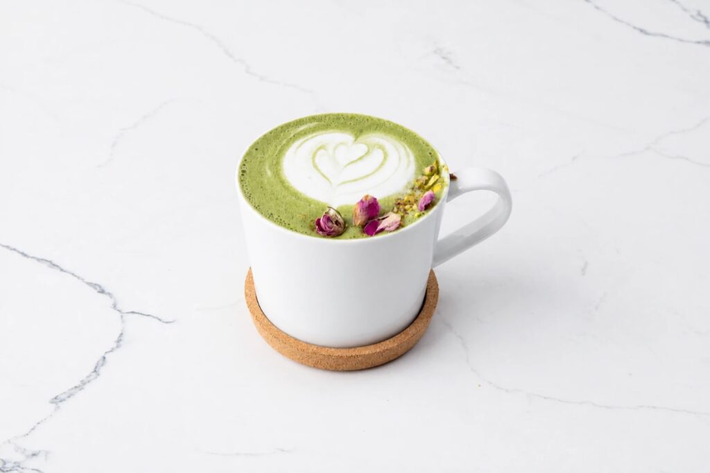 Matcha latte with latte art, rose petals and pistachio at Blue Ridge Cafe in Ridgewood, NJ