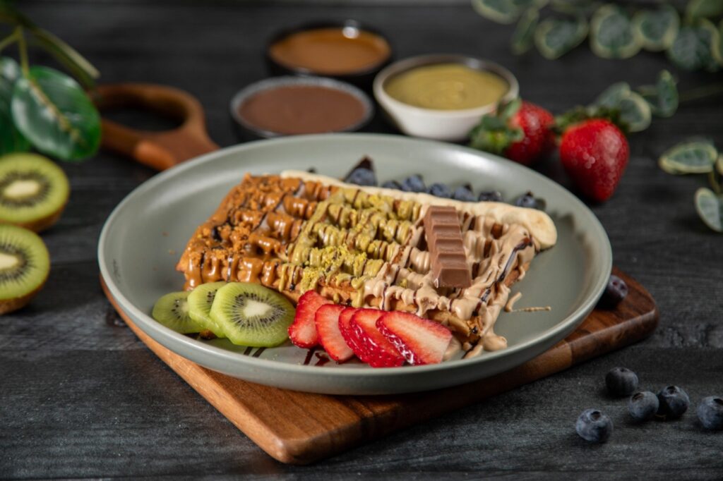 Waffle with Lotus, pistachio and chocolate sauces and fresh fruit at Bora Bora Smoothie Cafe