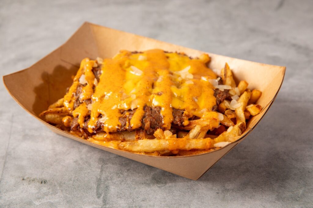 Loaded fries with smash patty, cheese and sauce at Hitit Burger in Bayside, Queens