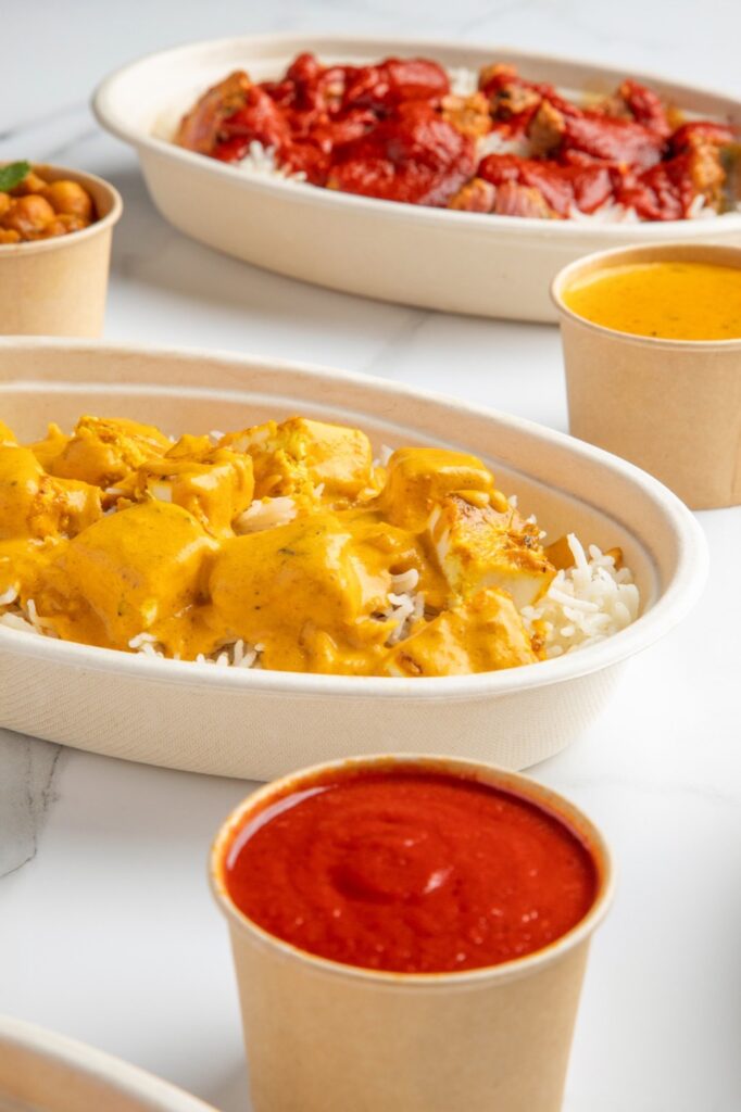 Paneer tikka masala bowl with sauces at Tandoori Twist in Valley Stream, Long Island