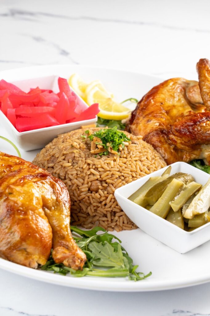 Roast chicken platter with spiced rice and pickles at The Olive Bistro in Little Falls, NJ