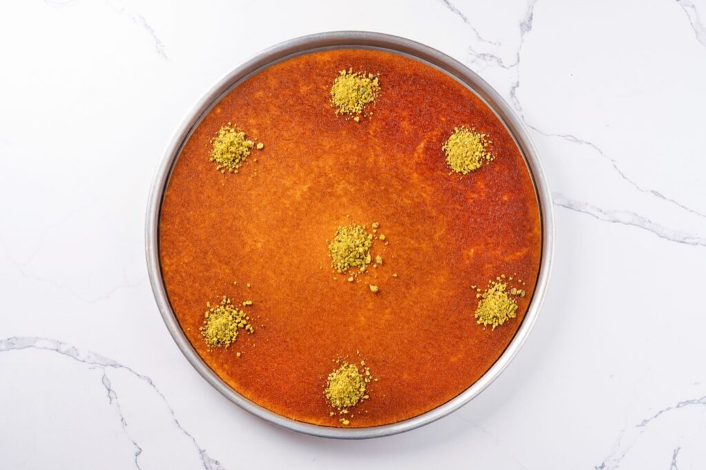 Full tray of golden kunafa topped with pistachio at Yaffa Coffee & Kunafa in Clifton, NJ