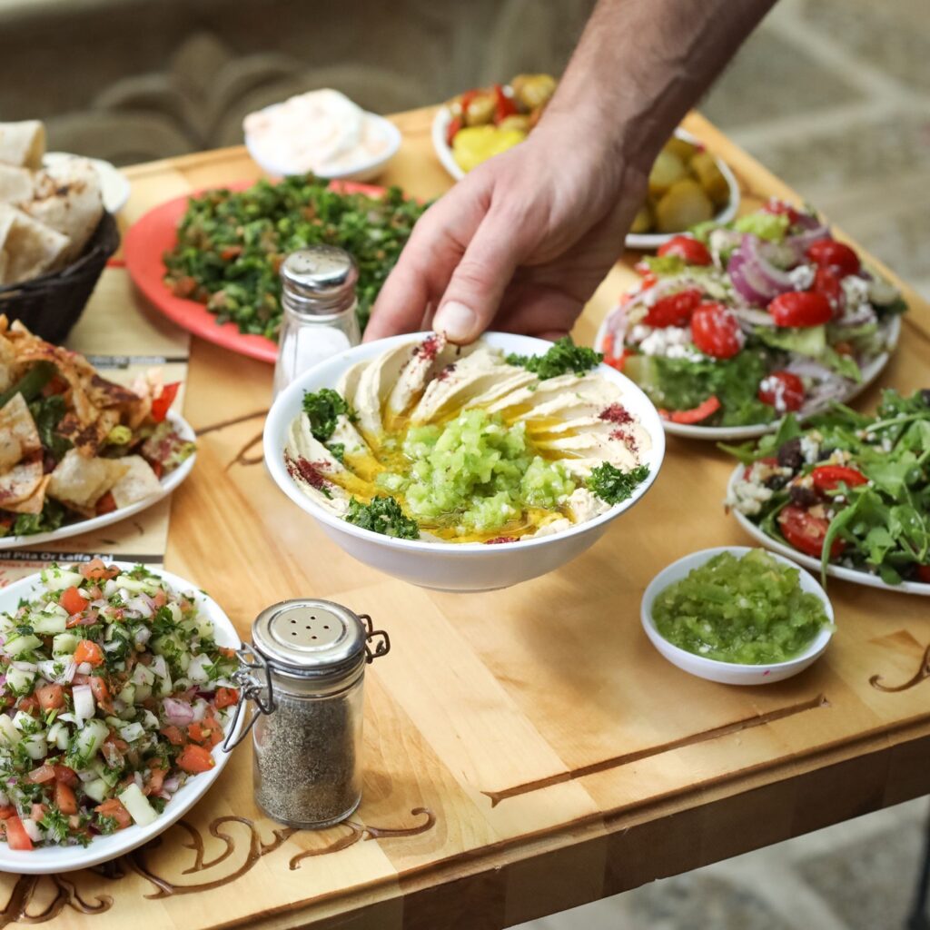 Hummus with olive oil and sumac served with a mezze spread at Zyara in Astoria, Queens